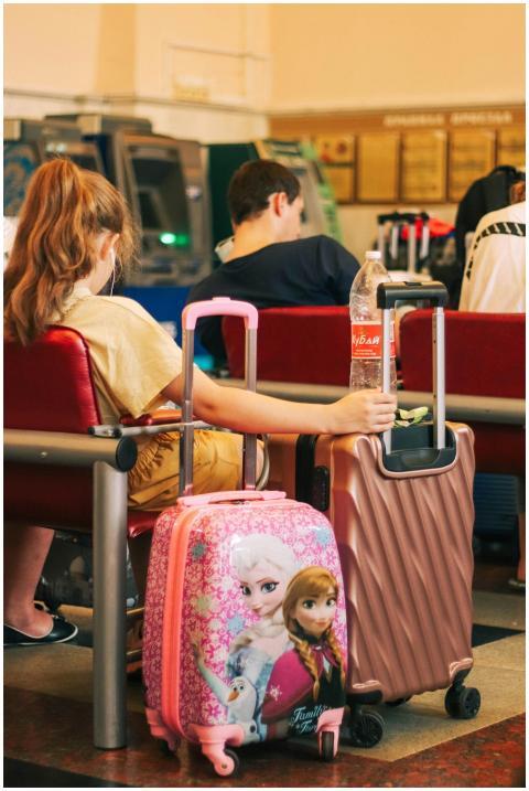Passengers waiting with colorful luggage at an air