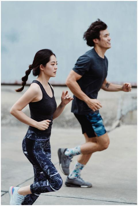A man and woman running outdoors for a healthy lif