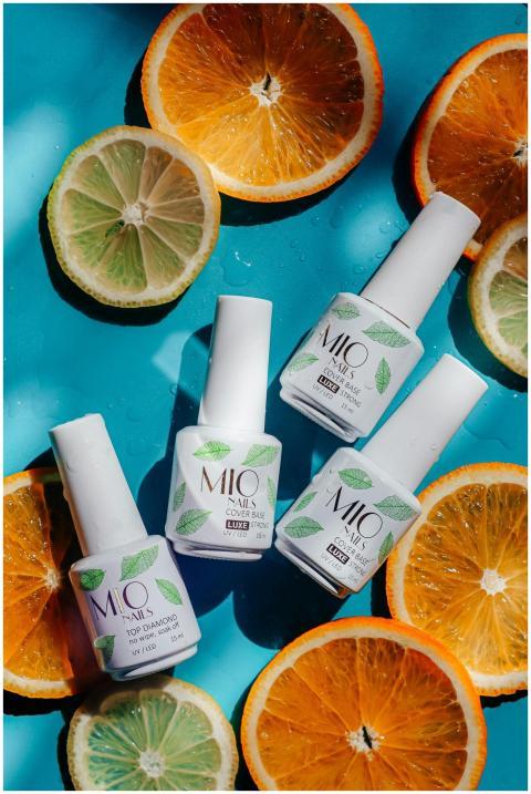 A colorful flatlay of nail polish bottles surround