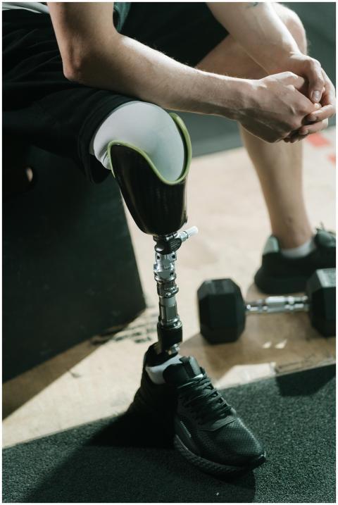 An individual with a prosthetic leg sitting on a b