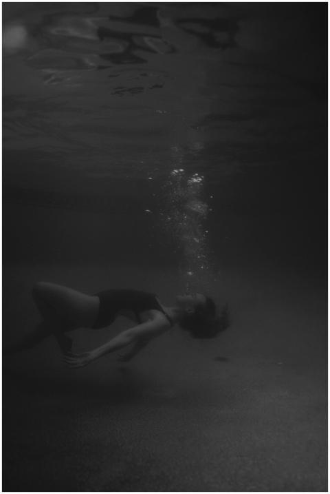 Graceful monochrome image of a woman floating unde