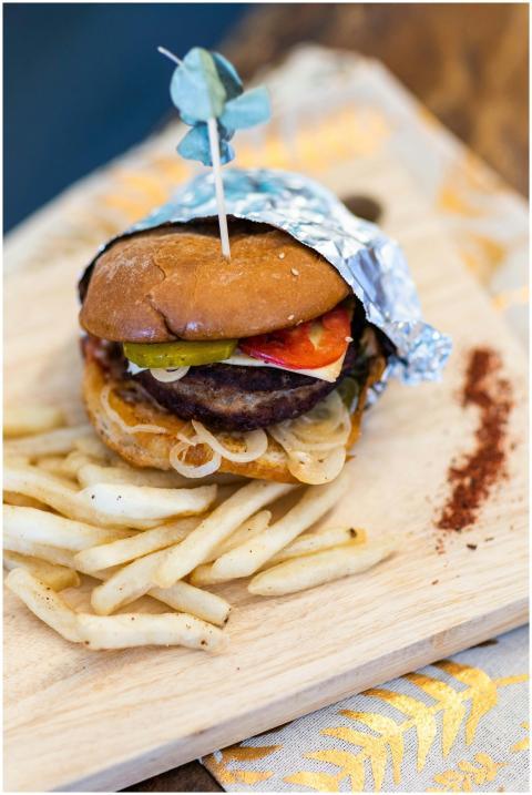 Close-up of a delicious hamburger and fries on a w