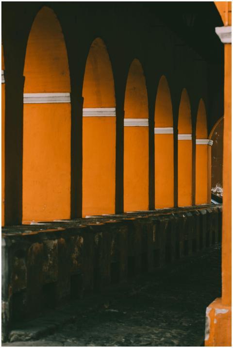 Rustic yellow colonial arches captured in Antigua