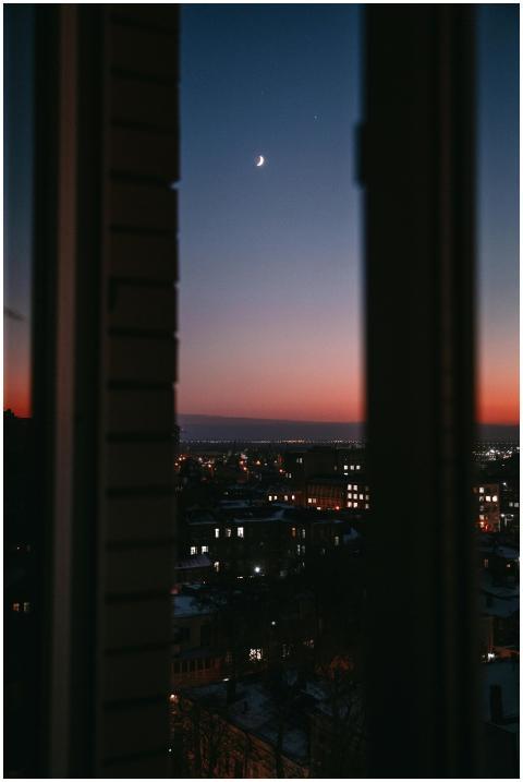 A beautiful cityscape at dusk framed by a window,