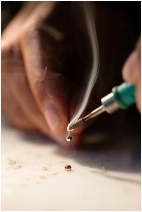 Detailed shot of soldering with smoke and precisio