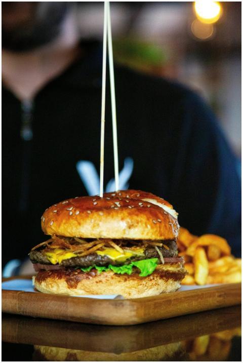 Close-up of a delicious cheeseburger and fries ser