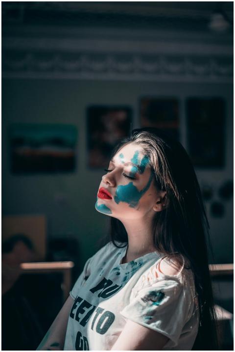 A creative portrait of a woman with vibrant blue f