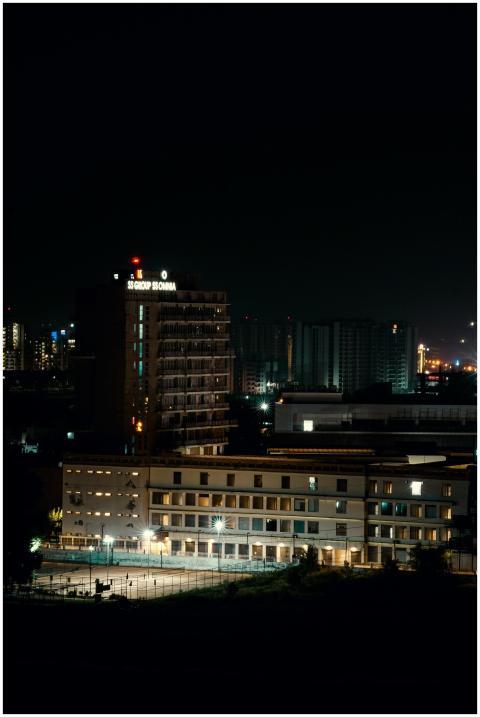 A serene night view of city buildings illuminated