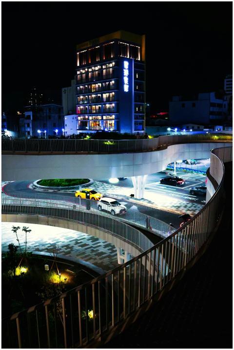 Brightly lit urban street with modern architecture