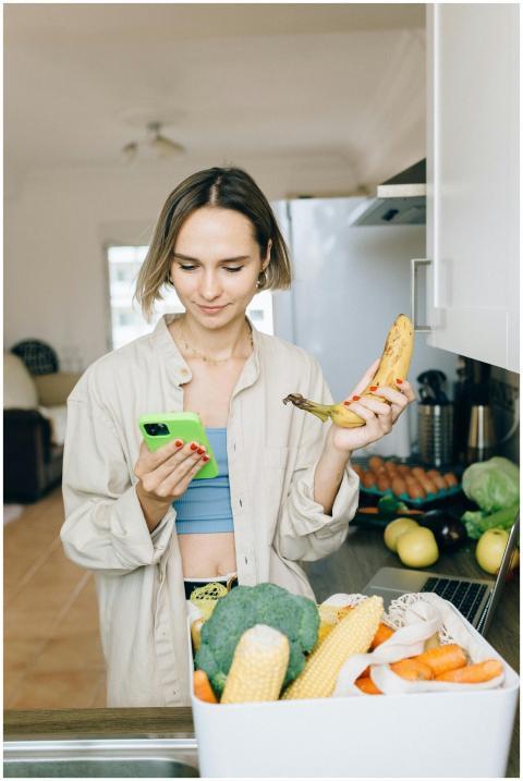 Young woman checks her smartphone while holding a