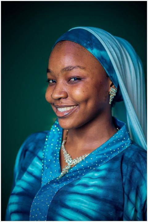 Vibrant portrait of a smiling woman in elegant blu