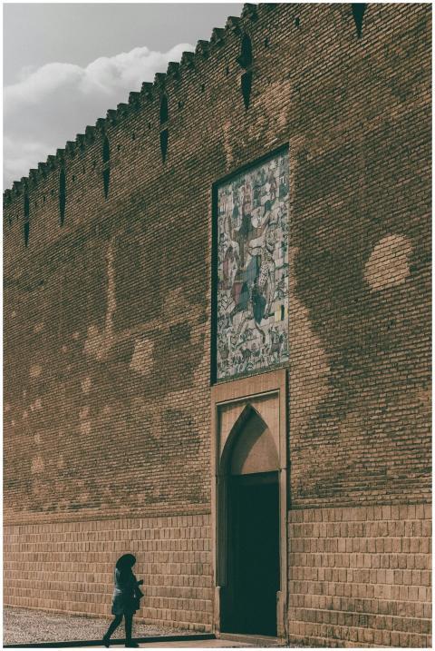 A visitor approaches the historic Karim Khan Citad