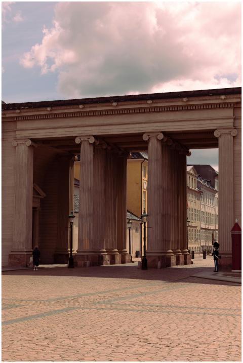 Elegant colonnade with columns under a cloudy sky