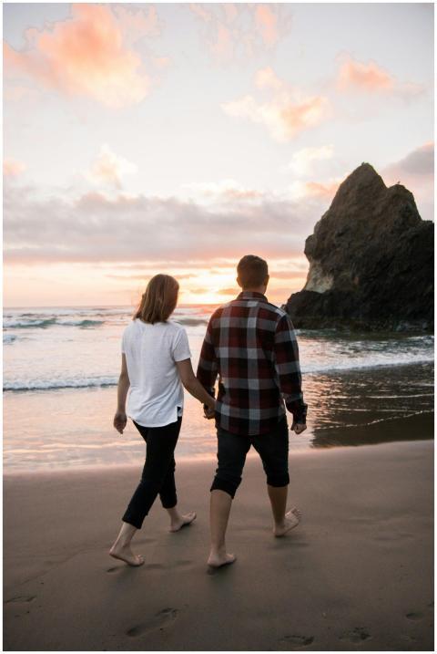 A couple holding hands while walking on a scenic b