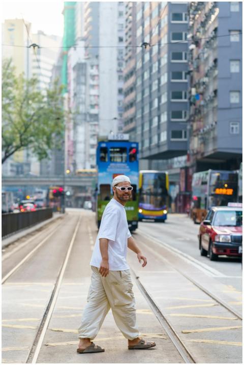 Casually dressed man walking on a busy Hong Kong s