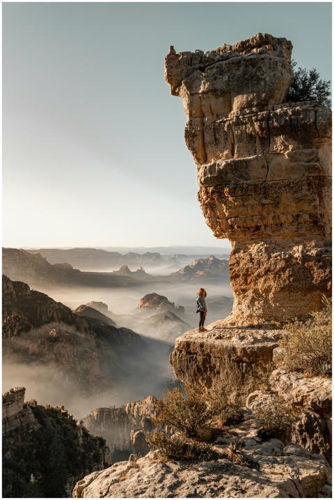 Side view of anonymous female traveler standing on