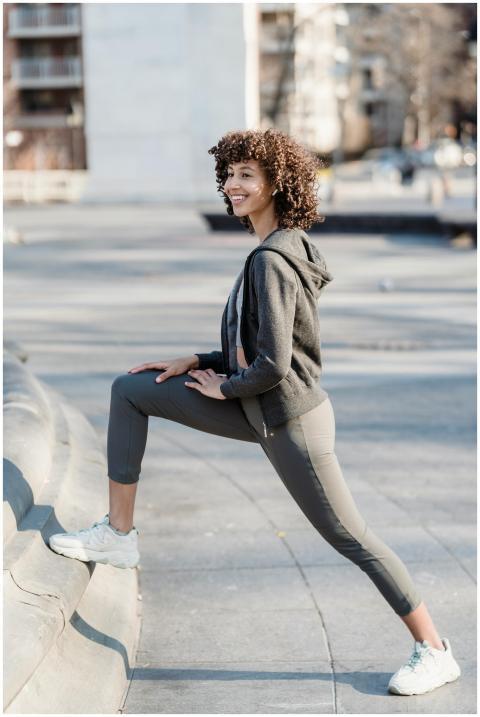 Full body side view of positive sporty ethnic fema