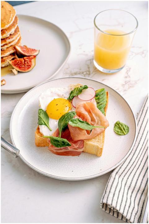 Delicious toast topped with prosciutto, egg, and g