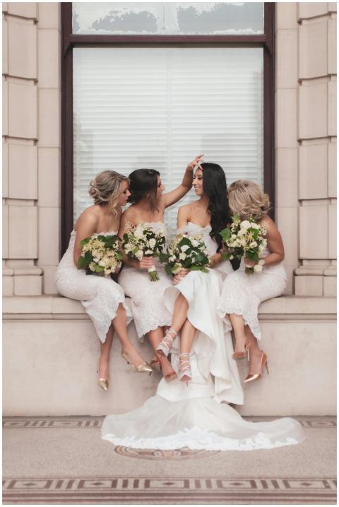 Bride and bridesmaids elegantly posed with bouquet