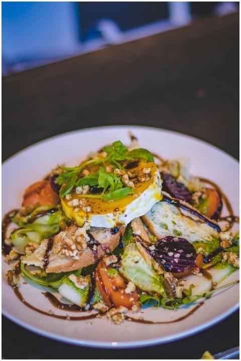 A vibrant gourmet salad with poached egg, fresh ve