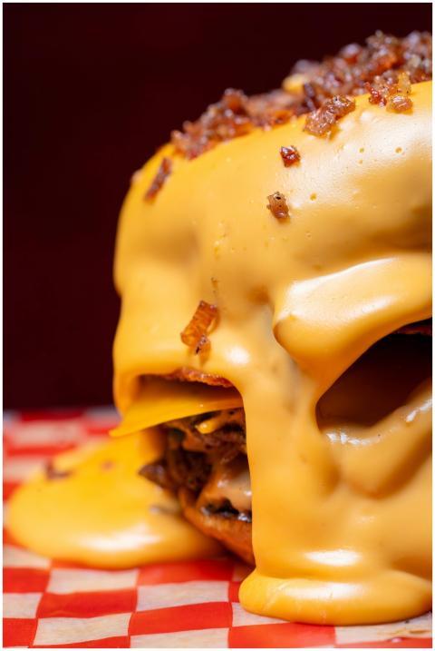 A delicious close-up shot of a burger overflowing