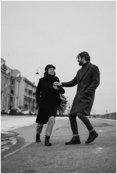 Couple holding hands and walking outdoors during w