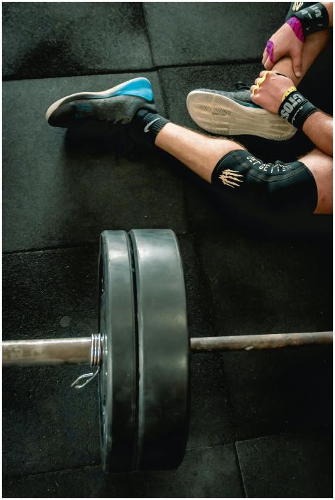 Close-up of an athlete in gym with weights focusin