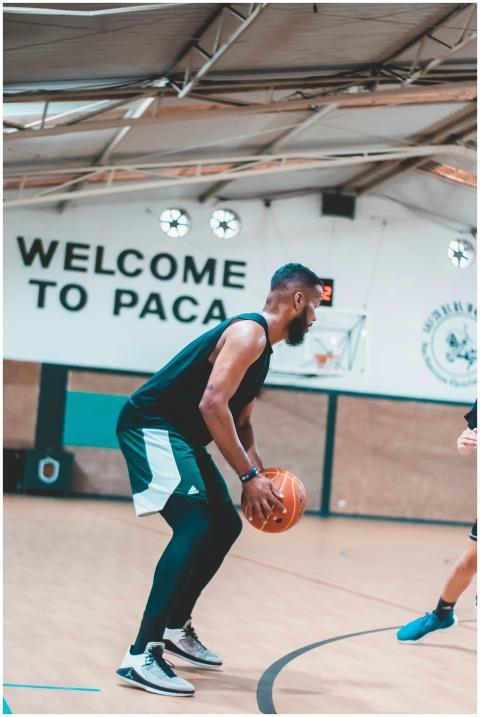 Man playing basketball indoors at PACA, showing in