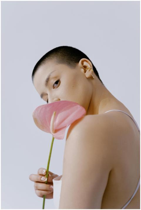 Portrait of a stylish woman holding a pink anthuri