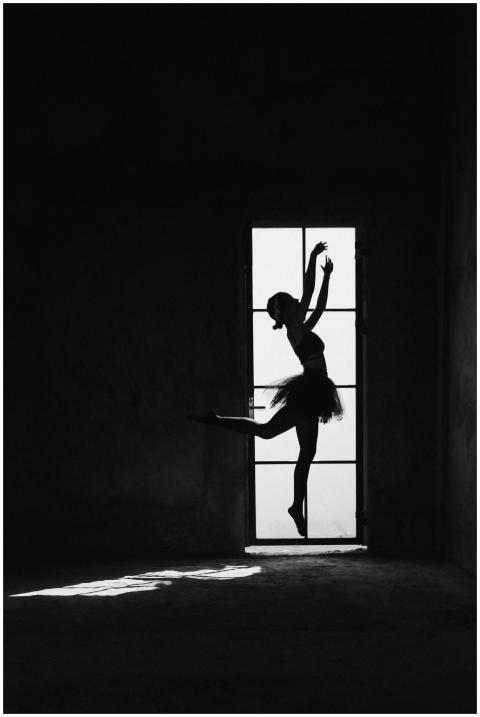 Black and white side view of anonymous female ball