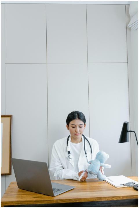 Female doctor in medical office examining a blue s