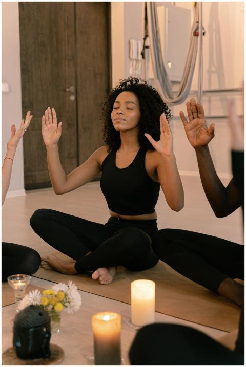 Diverse group practicing meditation indoors with c
