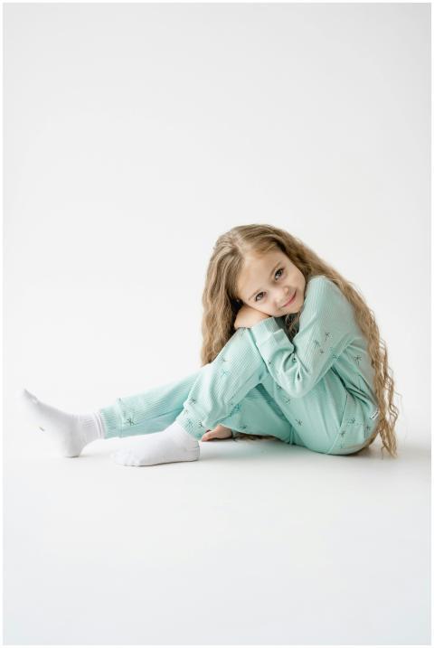 Charming young girl with long blonde hair sitting