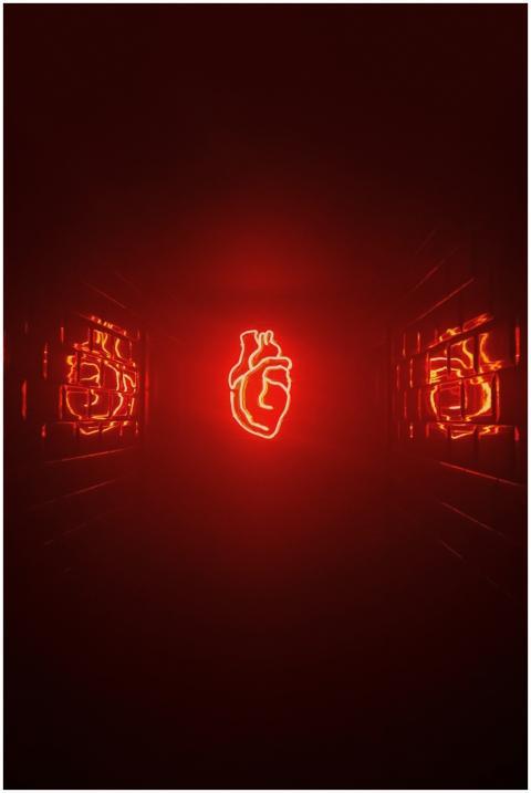 A vivid red neon heart glowing in a dark futuristi