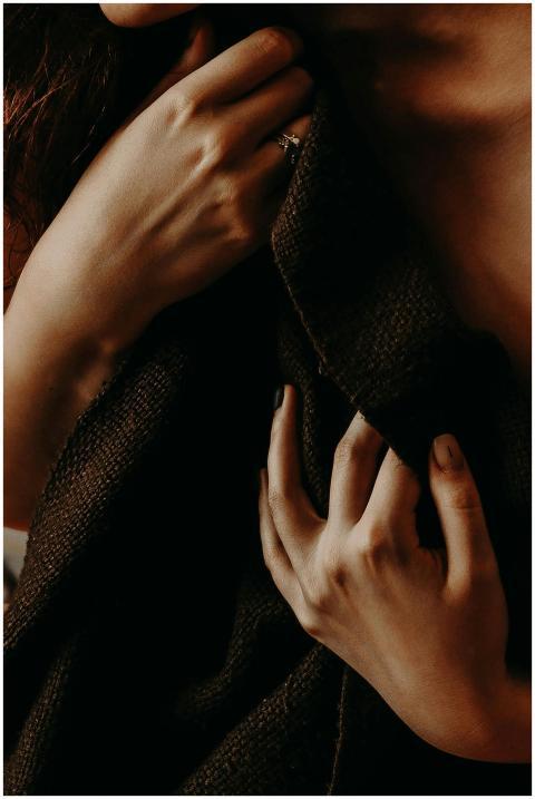 Elegant close-up capturing hands holding dark fabr
