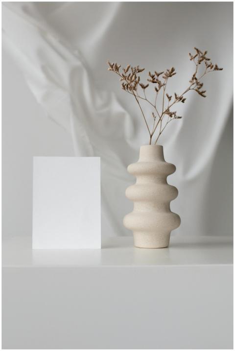 Elegant minimalistic setup with ceramic vase and b