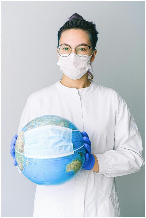 Conceptual image of a doctor holding a globe with
