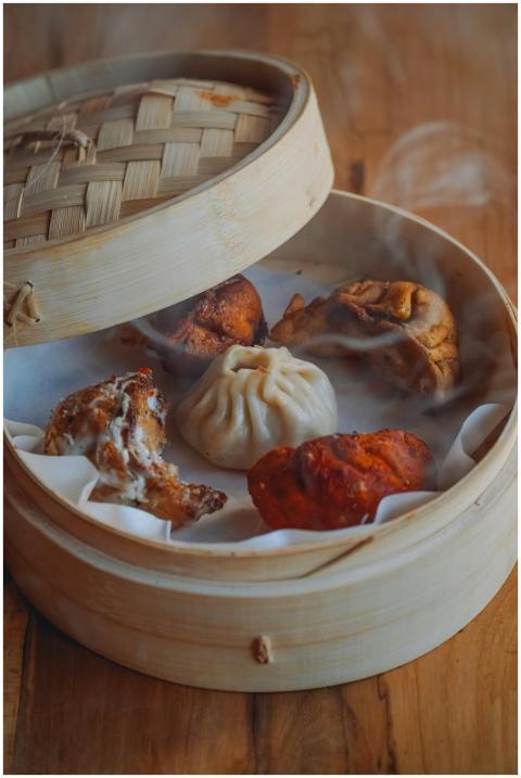A selection of steaming dumplings in a traditional