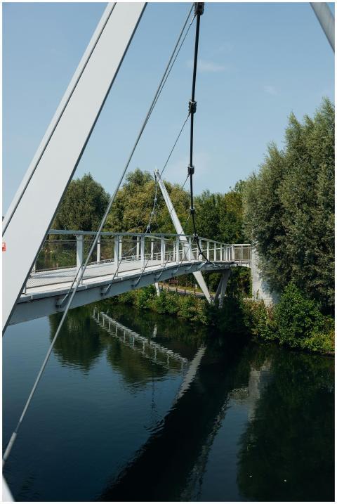 A contemporary footbridge crossing a serene river
