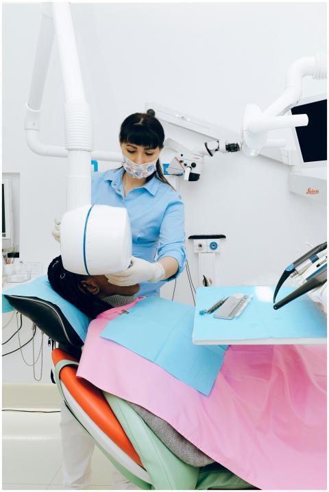 A dental professional uses advanced equipment to e