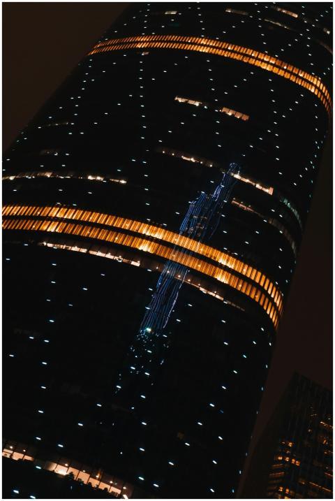 Illuminated skyscraper featuring reflective glass