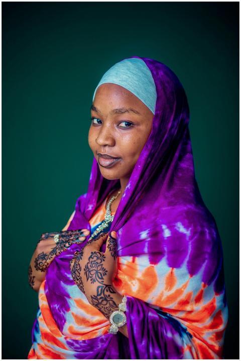 Elegant portrait of a woman wearing vibrant fabric