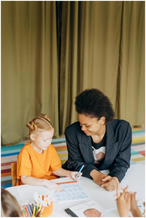 Educator and young girl collaborating on an educat