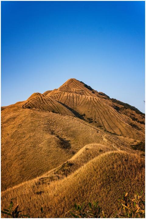 A stunning view of a golden pyramid-shaped mountai