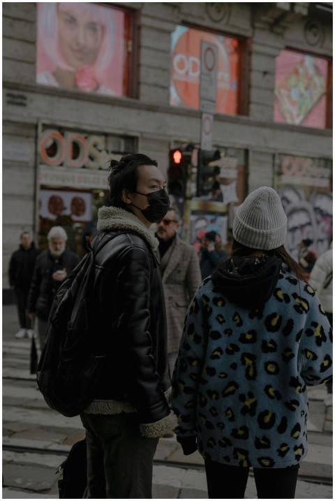 A busy urban street scene with pedestrians at a ze