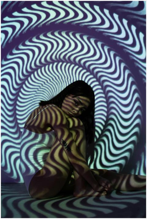 A woman in a distorted tunnel pattern, creating a