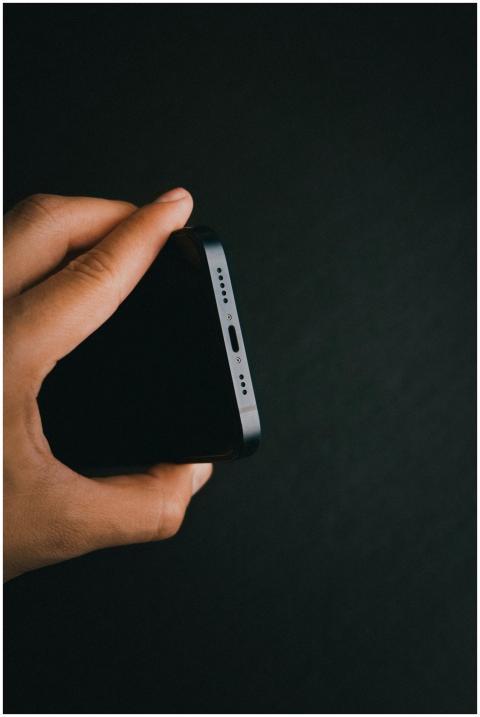 A detailed view of a smartphone being held against