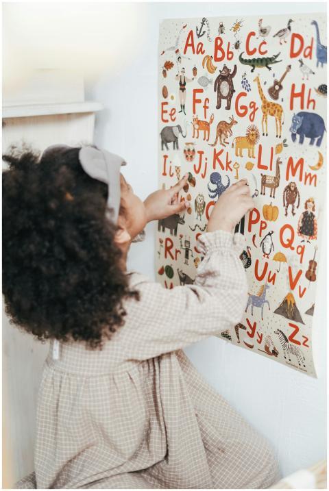 A young girl interacting with a colorful alphabet