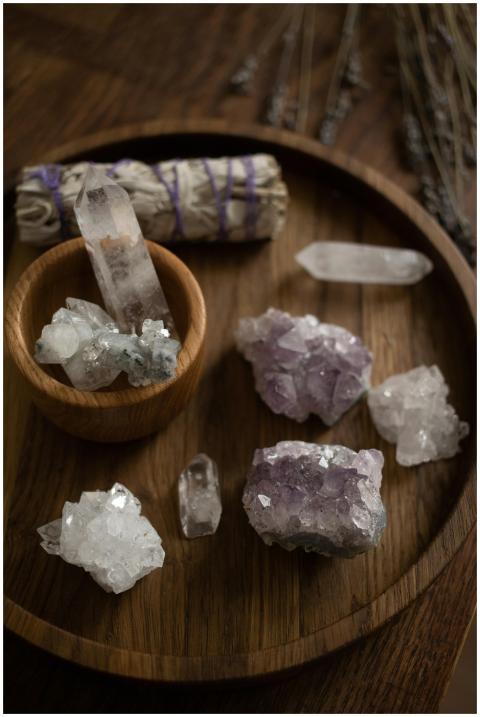 A collection of healing crystals on a wooden tray