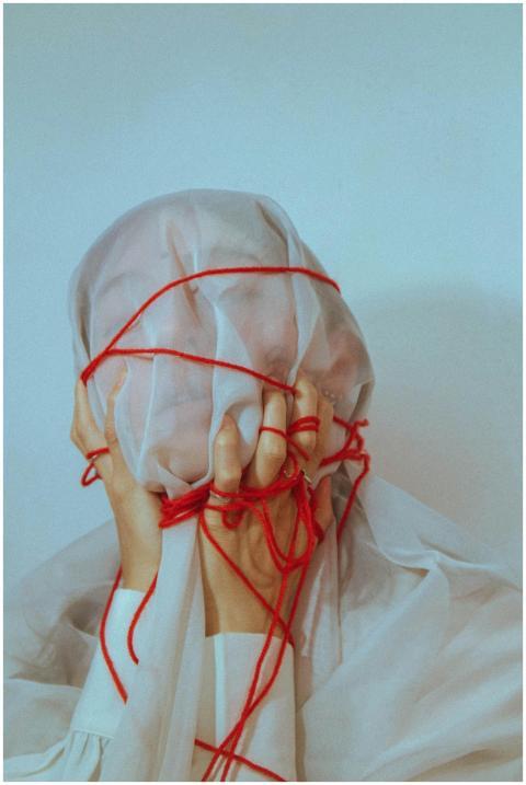 Surreal portrait of a covered face wrapped with re